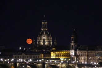Glowing strawberry moon on 11 June 2025 over Augustus Bridge and Church of Our Lady Dresden,