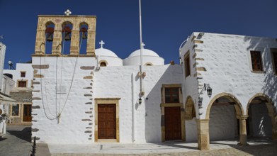 Church of Agios Ioannis Prodromos, white church with bell tower under a blue sky, traditional