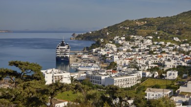 Coastal town with cruise ship and houses, sea and mountains in the background, Skala, harbour,