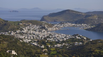 Far-reaching panorama of a town between hills and sea, islands in the distance, Skala, harbour,