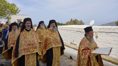 Priests in golden robes read from a Bible during a procession, Orthodox ceremony, monks of St