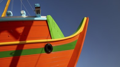 Close-up of the boat bow with orange and green paint, Diakofti boatyard, new construction of a