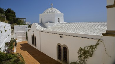 Cross-domed church Panagia Diasosousan, white church in Mediterranean style with dome and cross,