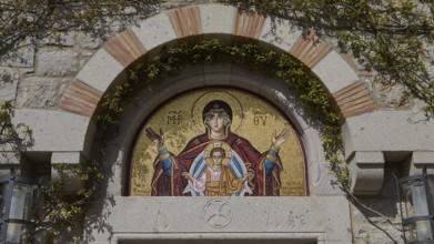 Mosaic above a door shows Mother of God with child, embedded in stone wall, woman's monastery,