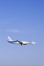 Passenger plane from Tui travel company flying on a blue sky, Mallorca, Spain