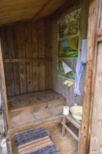 Interior of an old idyllic wooden outhouse for two in the swedish countryside, Sweden