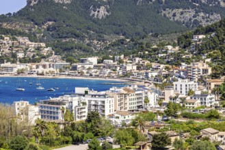 View at a tourist resort with houses by a seabay and mountains in the summer, Sant Elm, Mallorca,