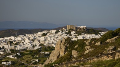 Village with white houses on a rocky hill overlooking the sea, Monastery of St John the Theologian,