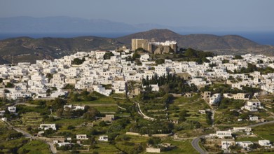 Panoramic view of a whitewashed village on a hill with a fortress on top, Monastery of St John the