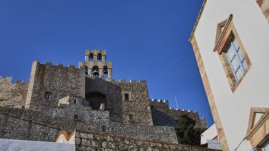 Stony old castle with walls and towers under a blue sky, Monastery of St John the Theologian,