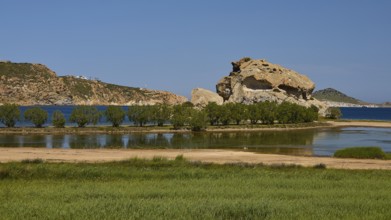 Rock in a lush green landscape with water and trees under a sunny sky, Rock of Kalikatsou, Seasonal