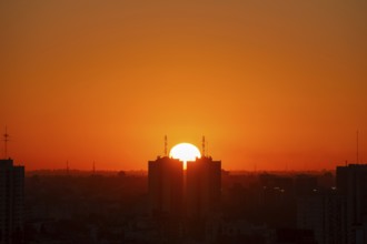 Sunset over skyscrapers in Buenos Aires, symmetry in photography, symbolic image for heat, global