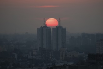 Sunset over skyscrapers in Buenos Aires, symmetry in photography, symbolic image for heat, global