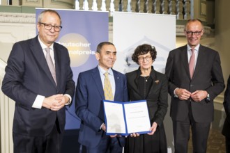 Thomas Mirow (Chairman of the Board of the German National Foundation), Ugur Sahin and Özlem Türeci