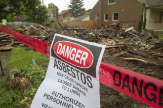 Detroit, Michigan - Signs warn of asbestos danger where a house was demolished. The house had been