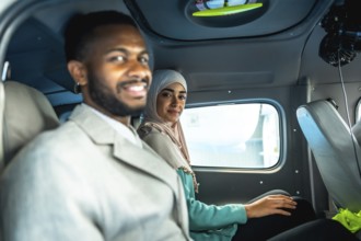 Business partners smiling while sitting in a private airplane, enjoying comfortable and efficient