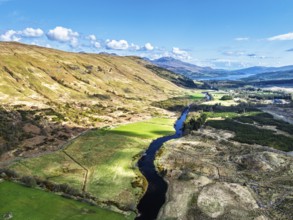 Farms and Mountains over River Dochart and Road A85 from a drone, Perthshire, Scotland, UK