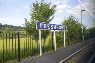 Freshford railway station platform sign taken through train window, Somerset, England, UK