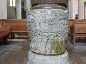 Historic baptismal font inside village parish church of Saint James, Avebury, Wiltshire, England,