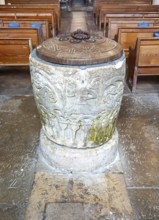Historic baptismal font inside village parish church of Saint James, Avebury, Wiltshire, England,