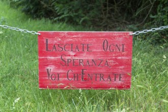Lasciate Ogni Speranza Voi Ch'Entrate sign on chain, Suffolk, England, UK - abandon all hope, ye