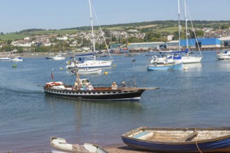 Shaldon ferry arriving, small boats in harbour at Back Beach, Teignmouth, south Devon, England, UK