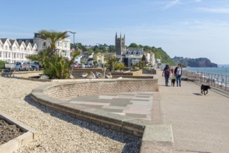 Seafront promenade view east towards St Michael's church, Teignmouth, south Devon, England, UK