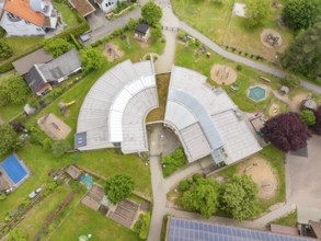 Building complex with an innovative architectural design and surrounding play and green areas,