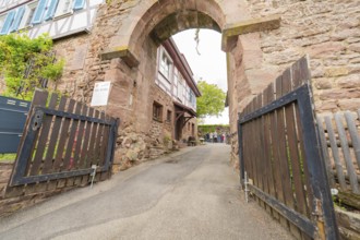 Entrance gate to an alley with traditional stone walls, historical ambience, family festival in