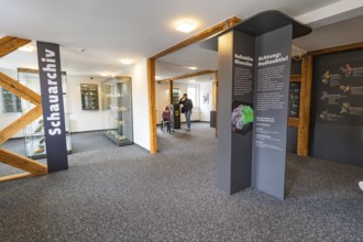 Interior of a mineral museum with information panels on radioactive materials, family festival in