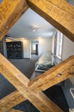 Empty modern showroom with glass showcases and wooden structural elements, family party in