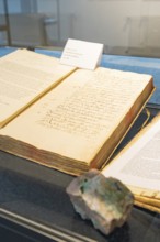 Old book with handwritten notes displayed in a showcase, Family Festival in Neubulach, Calw