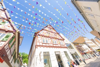 Cheerful sight of a decorated city street with colourful flags, Calw station festival, Black
