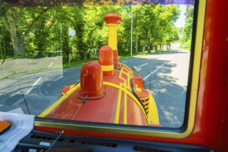 View from a train on a green forest road in sunny weather, Calw railway station festival, Black