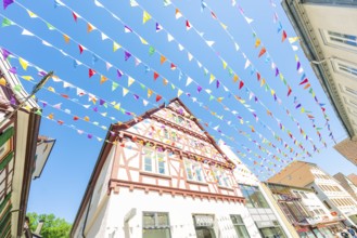 Colourfully decorated town with half-timbered houses and colourful flags in summer, Calw station