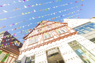 Colourfully decorated old town with blue sky and pennants, Calw station festival, Black Forest,