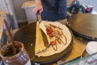 Crepes with Nutella and strawberries on a hot pan, Calw railway station festival, Black Forest,