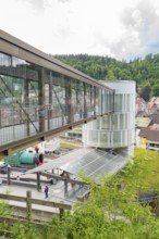 Modern bridge and tower in an urban landscape with hills in the background, Zob extension with