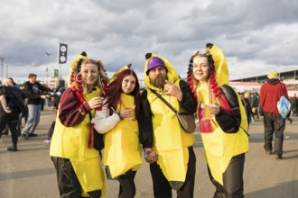 Festival visitors from Ukraine are at Rock am Ring for the 4th time and pose in banana costumes at