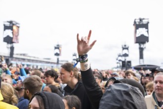 A festival visitor shows the French fries fork at the Rock am Ring Festival on Friday, Nürburgring
