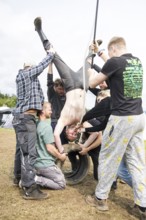 Festival visitors drinking from a funnel on a campsite at the Rock am Ring Festival on Saturday,