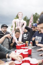 Festival visitors play a drinking game on a campsite at the Rock am Ring Festival on Saturday,