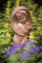 Terracotta statue, girl, between spotted loosestrife (Lysimachia punctata), also spotted