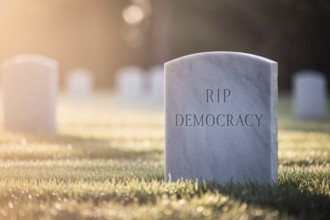 White tombstone in graveyard with text RIP Democracy. Visual metaphor for the decline of democratic
