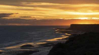 Sunset on the Atlantic coast of Patagonia at Balneario El Condor with the largest parrot colony in