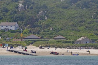 Coastal landscape with beach, houses and green hills in the background, relaxed atmosphere, Isles