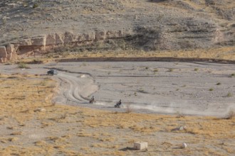 People riding all terrain vehicles through Echo Wash at Echo Bay, Nevada, USA
