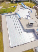 Focus on part of the swimming area with water slides and adjacent walkways, renewal of the swimming