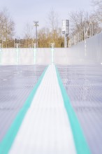 Empty swimming lane with focus on coloured lines and textured surface in the outdoor area, renewal