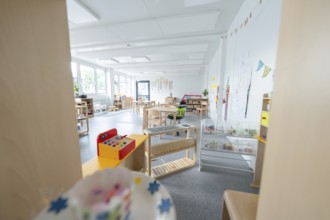 Light-flooded kindergarten room with toys and wall decorations, transitional containerised daycare